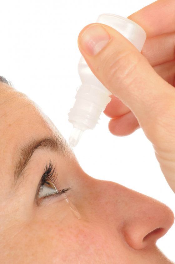 lubricant eye drops being dropped in an eye to cure conjunctivitis